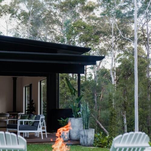 Custom home builders Sunshine Coast: Greystone Construction alfresco deck and fire pit surrounded by native bushland