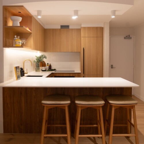 Modern timber kitchen with stone island benchtop in a Greystone custom-built home, Sunshine Coast